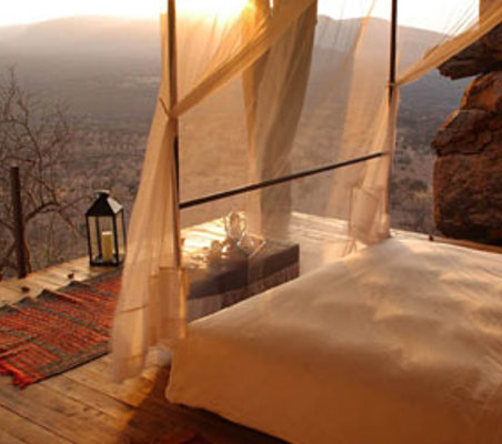 view from luxury lodge bed deck overlooking samburu plains safari